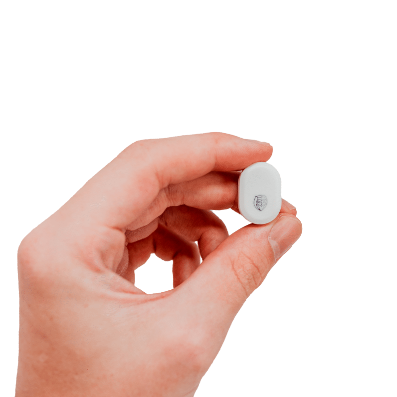 Person holding the NightOwl home sleep test device against a white background